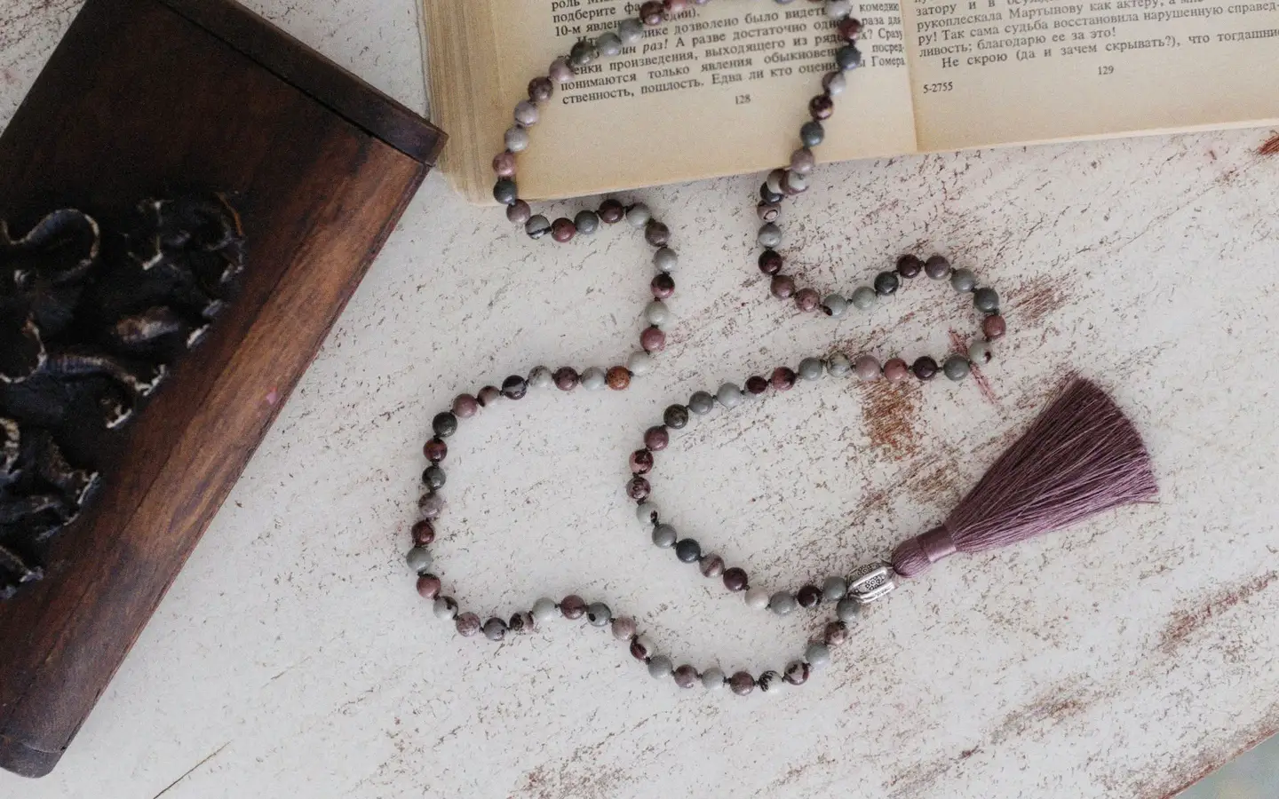 Close view of beads being threaded by hand